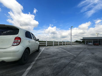 Car on road against sky in city