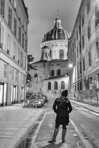Full length rear view of man walking in city