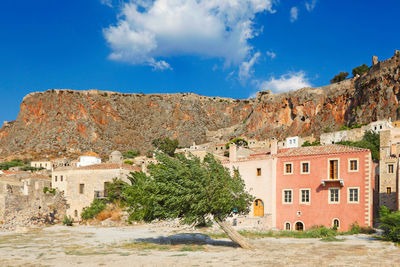 Trees and buildings against blue sky