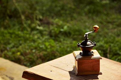 Close-up of coffee grinder on table in park