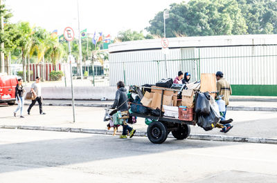 Man carrying cardboard boxes on cart