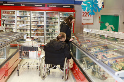 Female carer helping woman with shopping