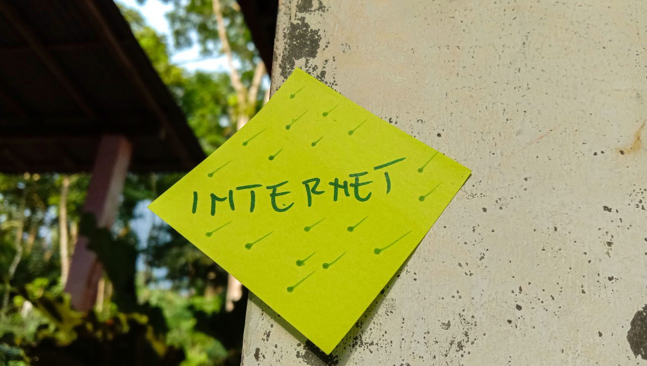 yellow, green, communication, sign, text, western script, no people, focus on foreground, warning sign, close-up, tree, day, information sign, guidance, outdoors, nature, note, road sign, message, adhesive note, leaf