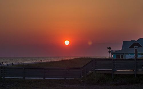 Scenic view of sea against orange sky