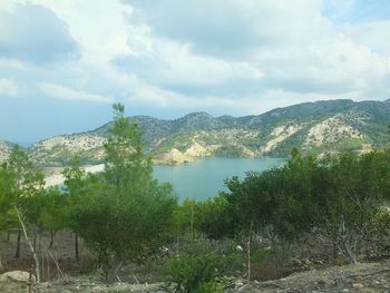 Scenic view of lake and mountains against sky