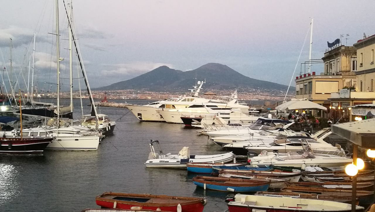 transportation, nautical vessel, mode of transport, boat, moored, water, mast, mountain, harbor, sailboat, sea, sky, mountain range, waterfront, day, ship, no people, tranquility, scenics