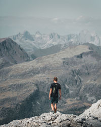 Man standing on rock against mountains