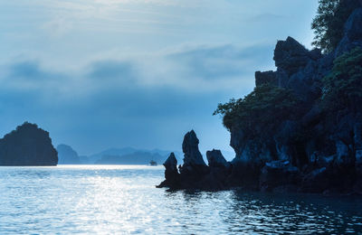 Rock formation in sea against sky