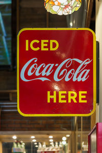 Low angle view of warning sign on restaurant at night