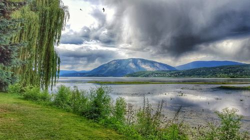 Scenic view of lake and mountains against sky