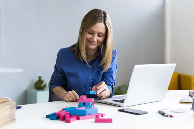 Mid adult woman using laptop on table