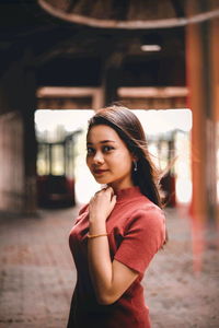 Portrait of smiling young woman standing outdoors