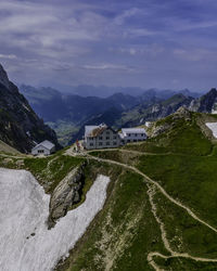 Scenic view of buildings and mountains against sky