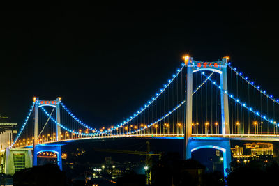 Illuminated suspension bridge at night