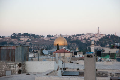 View of buildings in city against clear sky