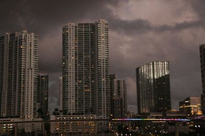 Skyscrapers in city against sky at night