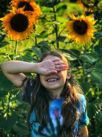 Portrait of smiling girl with pink flower