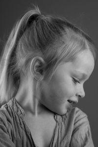 Close-up of cute girl looking down