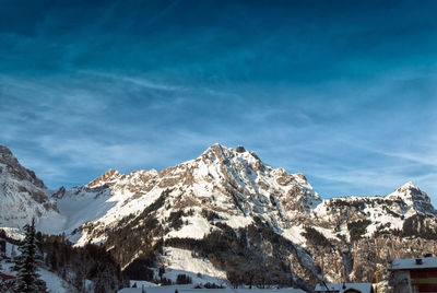 Scenic view of snowcapped mountains against blue sky