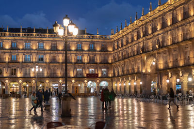 People walking in illuminated building at night