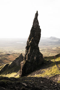 Rock formation on land against sky