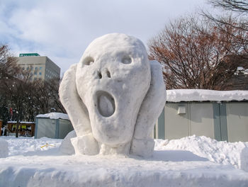 Statue against snow covered sky during winter