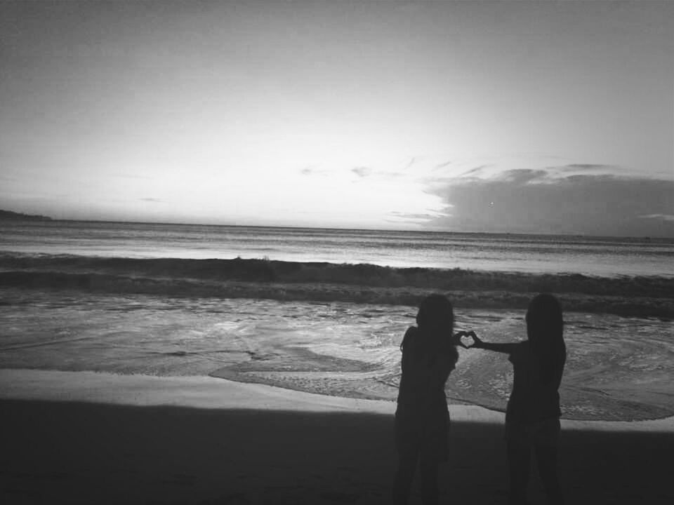 sea, horizon over water, beach, water, shore, silhouette, leisure activity, lifestyles, sky, men, wave, scenics, beauty in nature, tranquil scene, tranquility, nature, standing