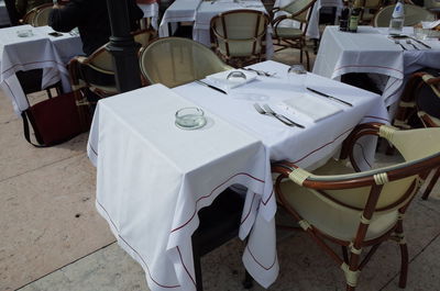 High angle view of tables and chair at sidewalk cafe