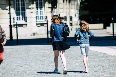 Rear view of women walking on street