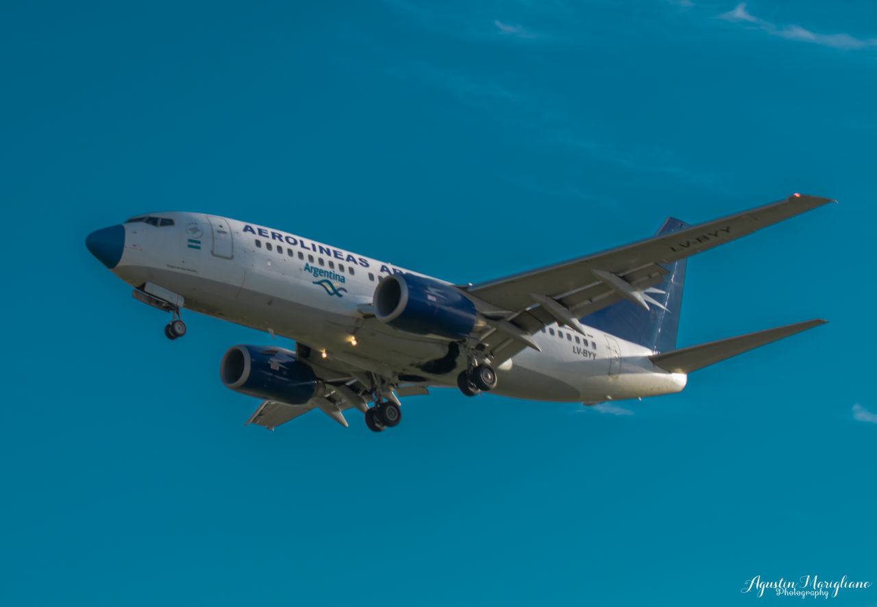 LOW ANGLE VIEW OF AIRPLANE FLYING IN SKY