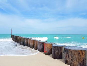 Scenic view of beach against cloudy sky