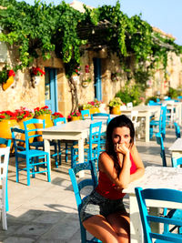 Portrait of woman sitting on chair