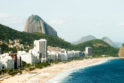 View of buildings by sea against sky