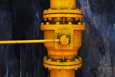 Close-up of fire hydrant against wall