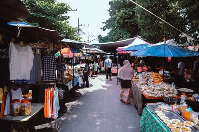 People at market stall in city