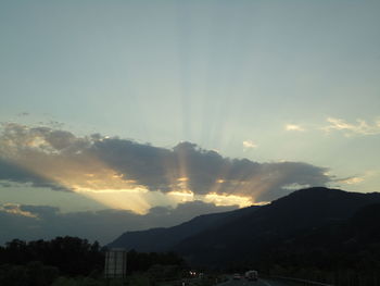 Scenic view of mountains against sky at sunset