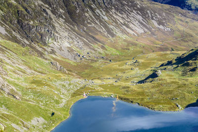 Aerial view of rescue helicopter flying over lake at snowdonia national park