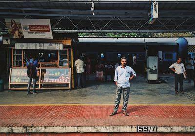 People walking on railroad station platform