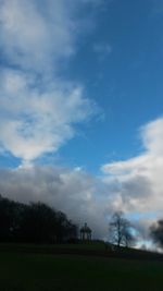 Scenic view of grassy field against sky