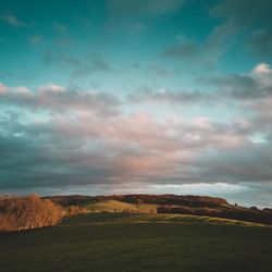 Scenic view of field against sky during sunset