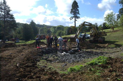 People working on farm against sky