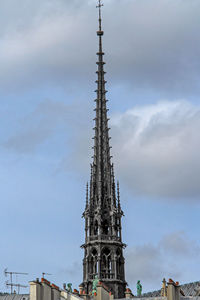 Low angle view of tower of building against cloudy sky