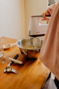 Child mixing ingredients for baking a cake