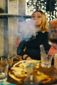 Young woman with drink on table