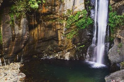 Scenic view of river flowing through rocks