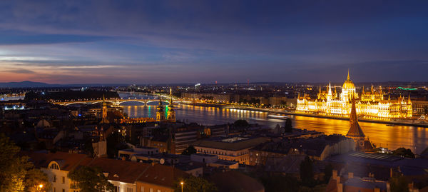 High angle view of city lit up at night