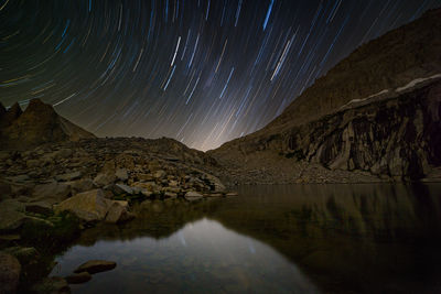 Scenic view of illuminated mountains against sky at night