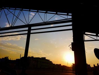 Silhouette city against sky during sunset