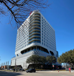 Low angle view of modern building against blue sky