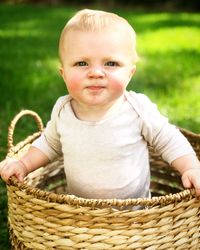 Portrait of cute baby boy in basket